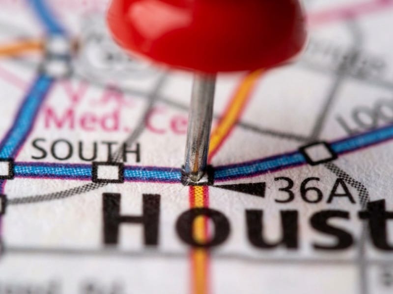 Red push pin marking a spot on a street map of Houston